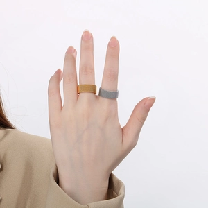 Close-up of gold and silver mesh texture rings with intricate woven pattern