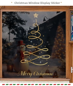 Close-up of golden Christmas tree window stickers with Merry Christmas greeting art