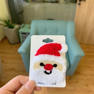 Macro view of Santa Claus chenille patch featuring plush embroidery and backing card