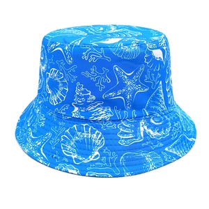 Close-up of bright blue fisherman hat featuring white sea shells and coral print