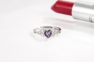 Macro view of purple heart-shaped stone and S925 silver Celtic knot ring detail