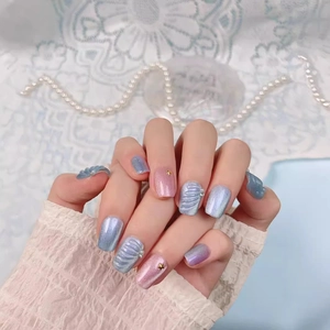 Handmade shell fishtail press-on nails with blue pink cat eye texture on hands