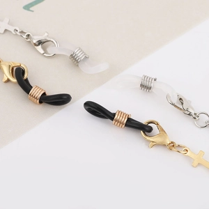 Detailed macro view of metal lobster clasps and rubber loops for eyewear chains