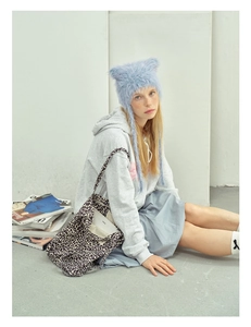 Detail of light blue fluffy cat ear beanie with soft faux fur texture for winter
