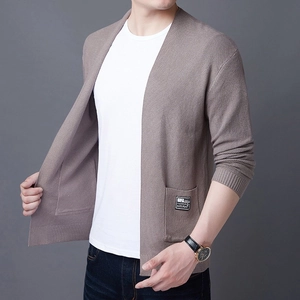 Detail of V-neck knitted cardigan showing taupe fabric texture and A&D fashion brand label
