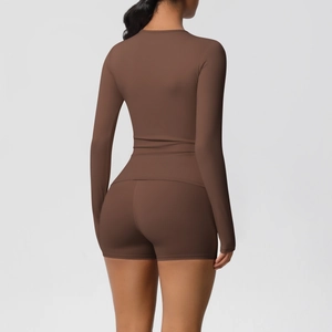 Detail of dark brown long-sleeve yoga top and high-waist shorts from a back view