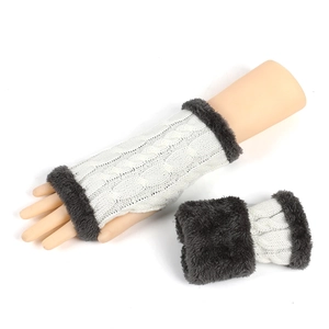 Close-up of white cable knit fingerless gloves with dark grey faux fur trim details