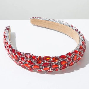 Macro detail of luxury baroque headband with red rhinestones and soft suede inner lining