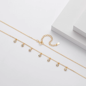 Detailed macro of S925 sterling silver gold plated chain with seven zircon pendants