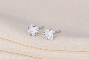 Macro shot of square-cut cubic zirconia earrings with S925 silver four-claw setting