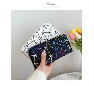 Close-up of geometric pattern ladies purse with rainbow lines and metallic zipper detail