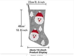 Detail of gray felt Christmas stocking featuring Santa Claus 3D decor and white snowflakes