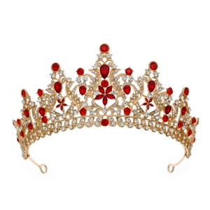 Macro detail of luxury gold crown featuring intricate red and clear rhinestone settings