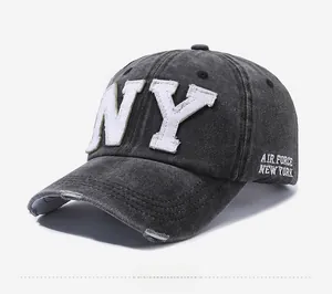Detail of NY embroidery and distressed brim on dark grey washed cotton baseball cap