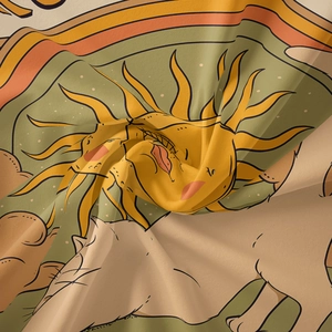 Detailed close-up of bohemian tapestry fabric showing vintage sun and cat illustration