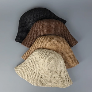 Detail view of woven straw sun hats in black, coffee, khaki, and cream colors