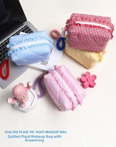 Flat lay of colorful quilted gingham makeup bags with ruffled edges and contrast pull handles