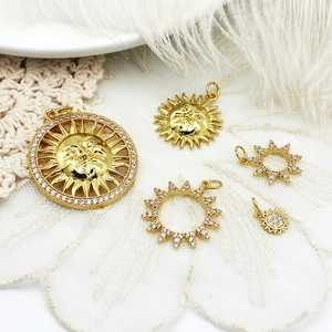 Golden sun flower charms with sparkling zircons on elegant white lace and feathers