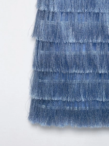 Detailed macro view of blue tiered fringe with metallic threads on this stylish dress