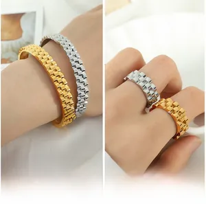 Macro shot of gold and silver watch-band style rings and bracelets in 18k gold plating