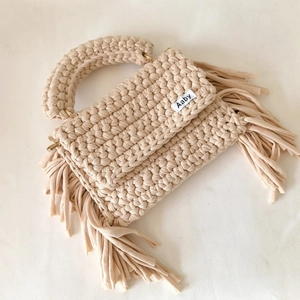 Handmade crochet crossbody bag in beige with tassel fringe and gold metal hardware