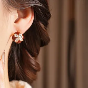 Elegant red clover earrings with white zircon accents in gold plating for women