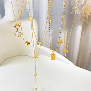 Gold titanium steel necklaces with flower, heart, and clover pendants and OT toggles