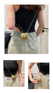 Detailed views of a mini gold heart acrylic chain bag worn by a model in three angles