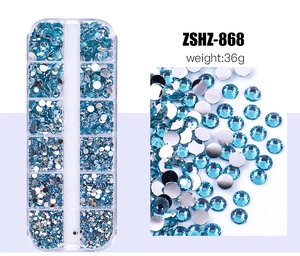 Detail view of 12-grid box with assorted blue flatback rhinestones for nail art DIY