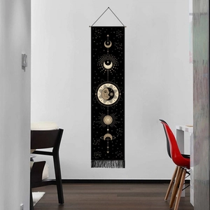 Detail of bohemian black sun and moon tapestry with white stars and decorative tassels
