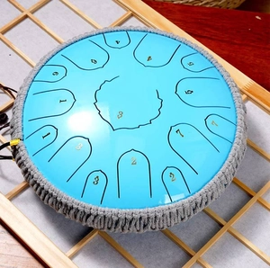 Detailed top view of blue steel tongue drum with gray woven rope and numbered notes