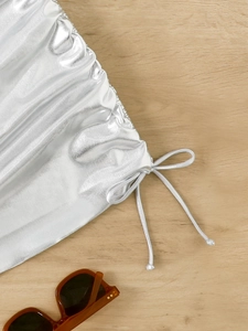 Detail view of silver metallic bikini skirt with drawstring design and wrinkled texture
