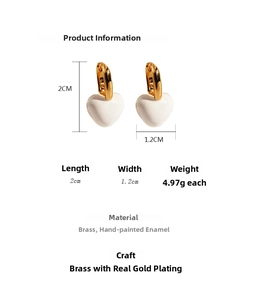 Detailed view of handmade white enamel heart earrings in 18k gold plated brass