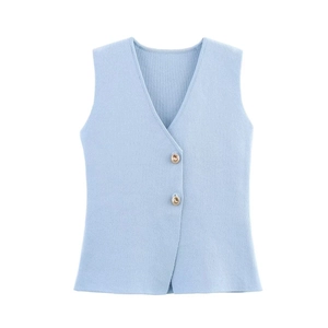Close-up of light blue knit vest featuring textured fabric and two gold buttons