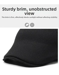 Detail of a black knit flat cap featuring a sturdy brim for a clear view and warm style