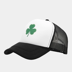 Detail view of trucker hat featuring green shamrock embroidery and breathable black mesh