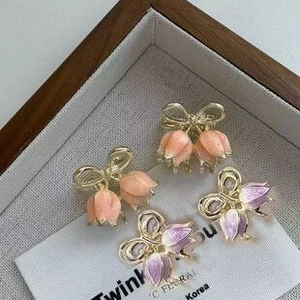 Set of four butterfly and tulip metal hair claws in pink, orange and lavender tones