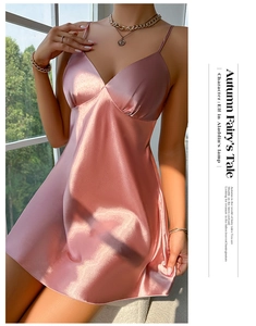 Detail of pink satin slip dress with V-neckline and elegant silky draping fabric