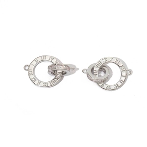Macro detail of silver ring connectors with Roman numerals and cubic zirconia inlay