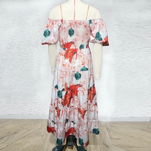 Detail of floral off-shoulder dress with puff sleeves and elastic waist on a mannequin