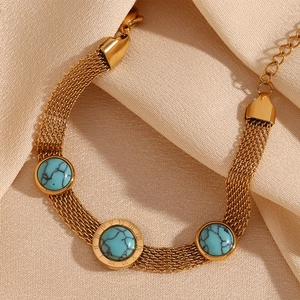 Macro shot of 18K gold plated mesh bracelet featuring round turquoise and roman numerals