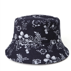 Close-up of the cotton fabric texture and floral print on this black reversible bucket hat
