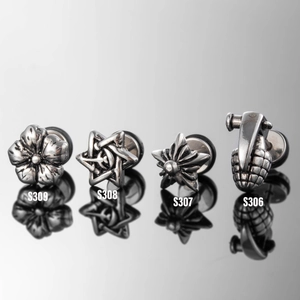 Polished stainless steel ear plugs with floral and star patterns on reflective surface