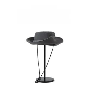 Close-up of a dark grey outdoor hat with breathable vents and adjustable chin strap