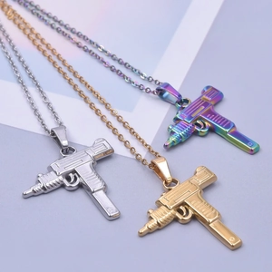 Detailed macro view of Uzi gun pendants in silver, gold, and aurora rainbow finishes