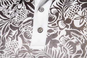 Close-up of the white placket with grey buttons on a piqué cotton polo shirt