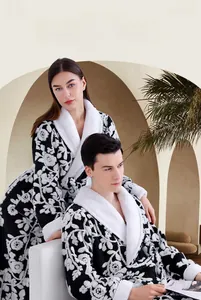 Detail of jacquard floral patterns on thick plush robe with sherpa fleece cuffs