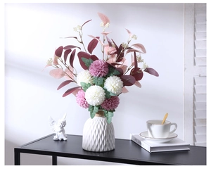 Elegant white ceramic vase with artificial ball chrysanthemums for home shelf decoration
