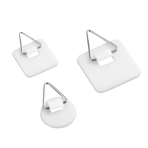 Three adhesive plastic plate hangers with triangular metal hooks in white color