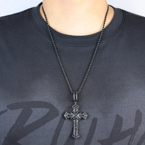 Close-up of a hip hop cross pendant with colorful zircons on a silver twist chain